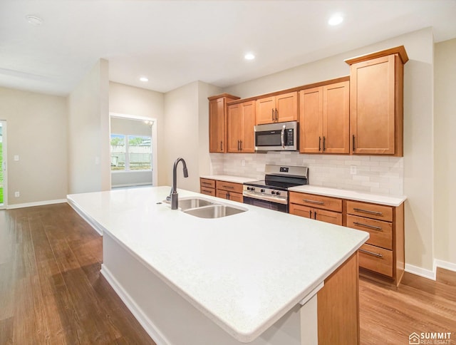 1120 Titan Dr, Hickman, NE 68372 - kitchen featuring stainless steel appliances, dark wood finished floors, backsplash, a center island with sink, and recessed lighting