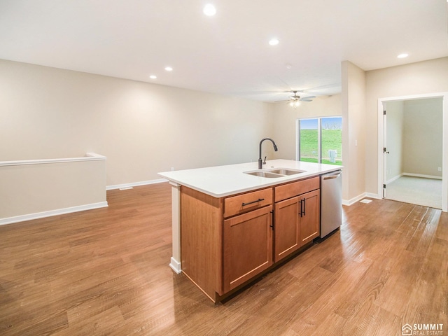 1120 Titan Dr, Hickman, NE 68372 - kitchen featuring stainless steel dishwasher, a ceiling fan, a kitchen island with sink, light wood-type flooring, and recessed lighting