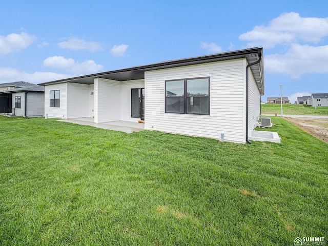 1130 Titan Dr, Hickman, NE 68372 - back of house featuring a lawn and a patio area