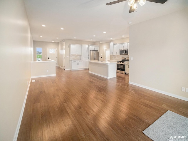 1130 Titan Dr, Hickman, NE 68372 - unfurnished living room featuring ceiling fan, wood finished floors, and recessed lighting