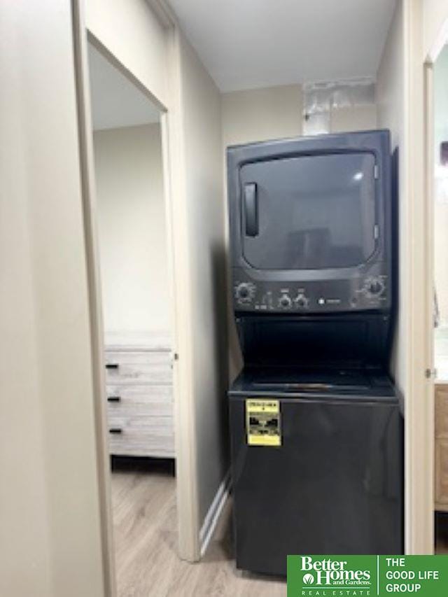 3000 Farnam St Unit S2D, Omaha, NE 68131 - laundry area featuring stacked washer / dryer and wood finished floors