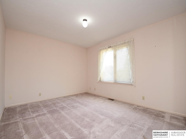 1502 Sunshine Blvd, Bellevue, NE 68123 - spare room featuring light carpet and baseboards