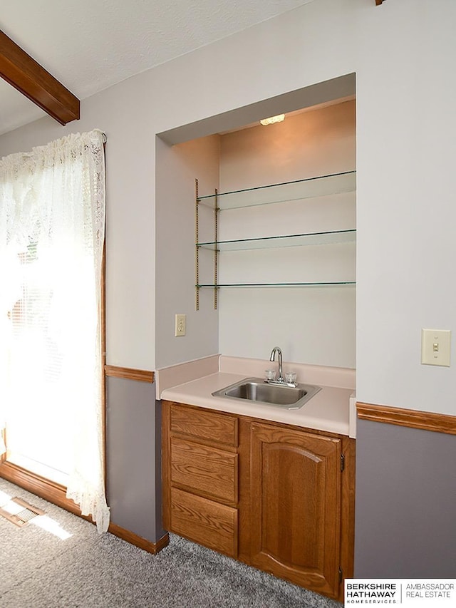 1502 Sunshine Blvd, Bellevue, NE 68123 - indoor wet bar featuring beamed ceiling and carpet