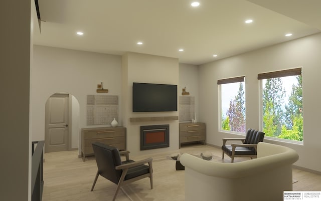 5518 S 200th Ave, Omaha, NE 68135 - living room featuring recessed lighting, arched walkways, light wood-style flooring, and a fireplace