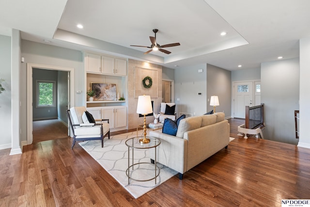 1320 S 190th Plz, Omaha, NE 68130 - living room featuring a tray ceiling, a ceiling fan, wood finished floors, and recessed lighting
