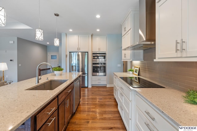 1320 S 190th Plz, Omaha, NE 68130 - kitchen featuring wall chimney exhaust hood, appliances with stainless steel finishes, white cabinets, pendant lighting, and light stone countertops