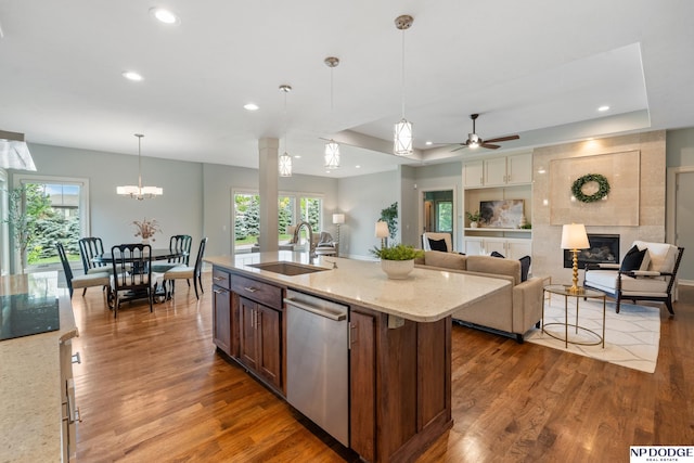 1320 S 190th Plz, Omaha, NE 68130 - kitchen with stainless steel dishwasher, wood finished floors, a tile fireplace, recessed lighting, and healthy amount of natural light