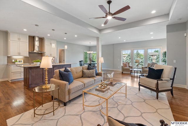 1320 S 190th Plz, Omaha, NE 68130 - living room with wood finished floors, recessed lighting, ceiling fan, and a tray ceiling