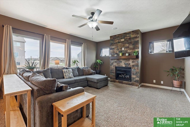 14611 S 24th St, Bellevue, NE 68123 - living room featuring ceiling fan, a stone fireplace, and carpet floors