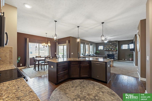 14611 S 24th St, Bellevue, NE 68123 - kitchen featuring dishwasher, a stone fireplace, a chandelier, dark wood finished floors, and open floor plan