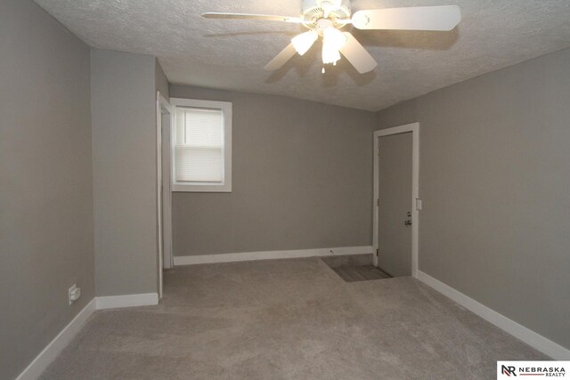 4300 N St, Lincoln, NE 68510 - spare room featuring a textured ceiling, carpet, and a ceiling fan