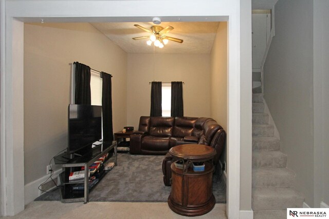 4300 N St, Lincoln, NE 68510 - carpeted living room with a ceiling fan and stairway