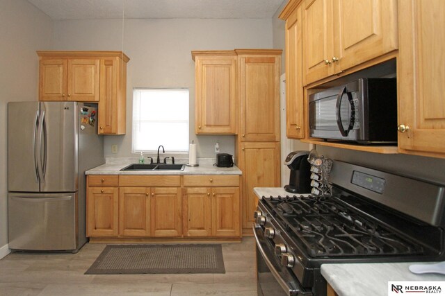4300 N St, Lincoln, NE 68510 - kitchen featuring appliances with stainless steel finishes, light countertops, and light wood-type flooring