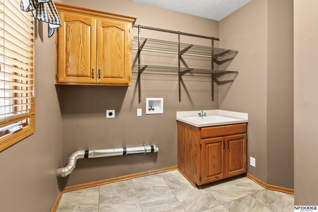 16367 Y St, Omaha, NE 68135 - laundry room featuring cabinet space, washer hookup, electric dryer hookup, and a textured ceiling