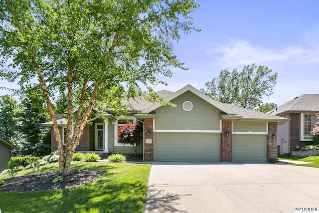 16367 Y St, Omaha, NE 68135 - view of front of property with a garage, driveway, a front yard, and brick siding