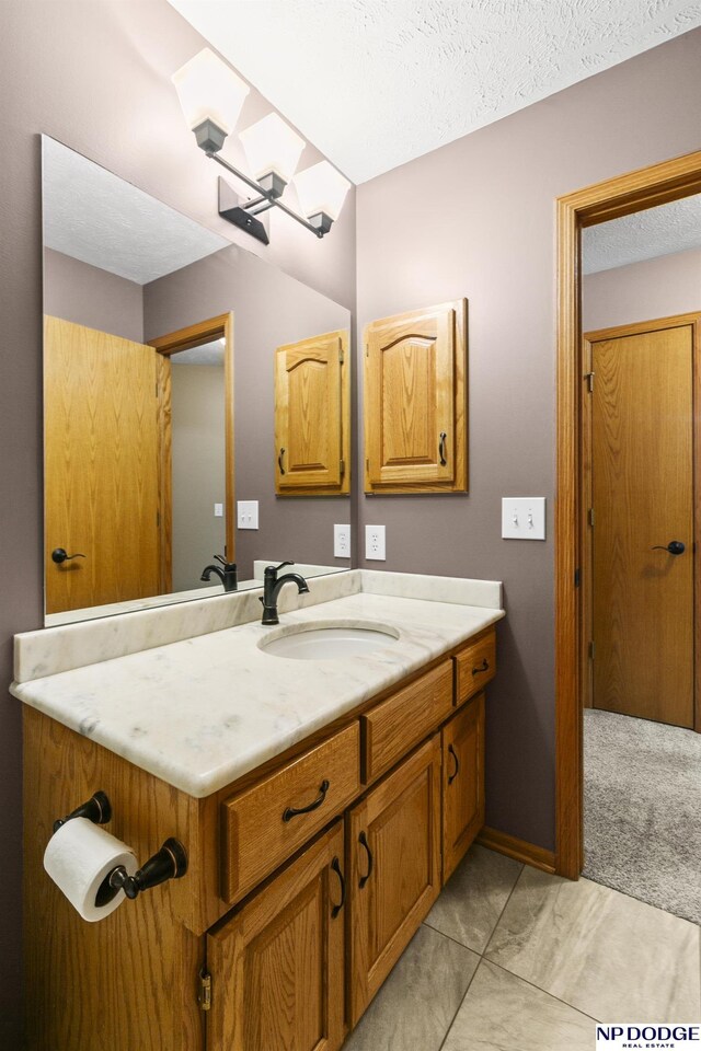 16367 Y St, Omaha, NE 68135 - bathroom with vanity, a textured ceiling, and a skylight
