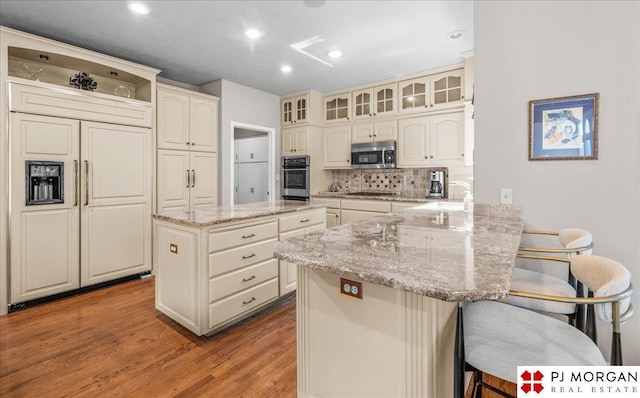 733 N 157th Cir, Omaha, NE 68118 - kitchen featuring stainless steel microwave, a peninsula, open shelves, a kitchen breakfast bar, and wood finished floors