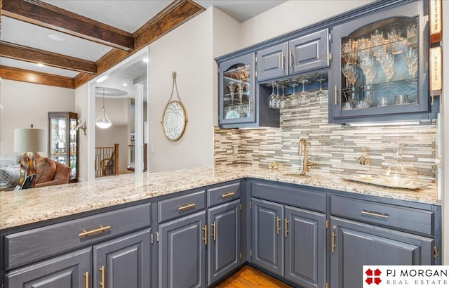 733 N 157th Cir, Omaha, NE 68118 - indoor wet bar with tasteful backsplash, beamed ceiling, and wood finished floors