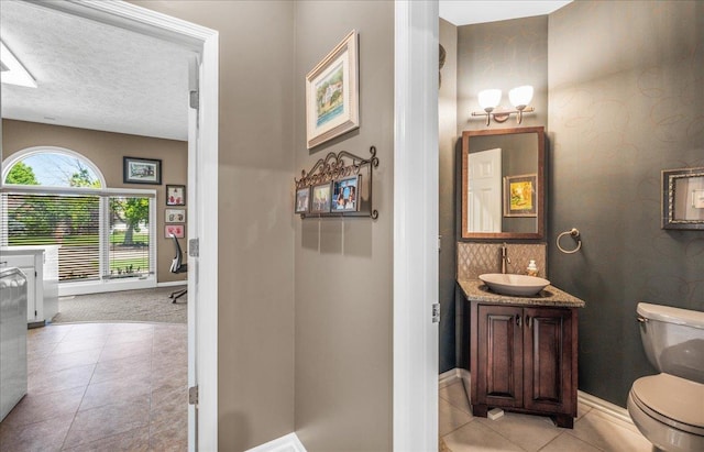 733 N 157th Cir, Omaha, NE 68118 - bathroom with vanity, tile patterned floors, and a textured ceiling