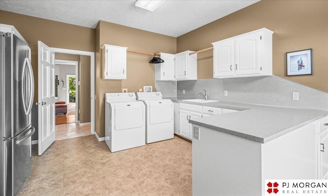 733 N 157th Cir, Omaha, NE 68118 - laundry area featuring cabinet space and washing machine and dryer
