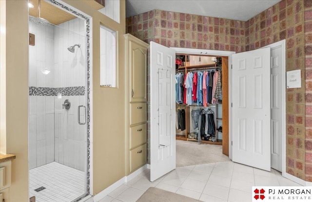 733 N 157th Cir, Omaha, NE 68118 - full bath featuring a stall shower, a walk in closet, and tile patterned floors