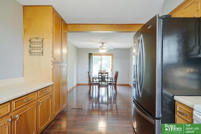 1800 N Clarmar Ave, Fremont, NE 68025 - kitchen with freestanding refrigerator, dark wood-type flooring, a ceiling fan, light countertops, and brown cabinets