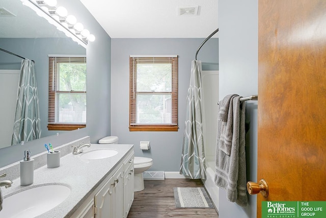 1800 N Clarmar Ave, Fremont, NE 68025 - bathroom with wood finished floors, double vanity, and shower / tub combo with curtain