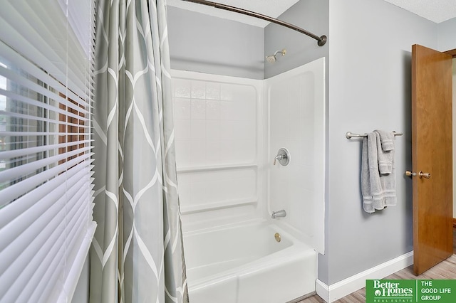 1800 N Clarmar Ave, Fremont, NE 68025 - full bathroom with shower / tub combo with curtain and wood finished floors