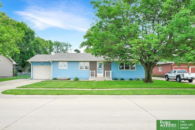 1800 N Clarmar Ave, Fremont, NE 68025 - view of front of property with driveway, a front yard, and a garage