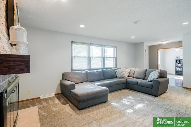 1800 N Clarmar Ave, Fremont, NE 68025 - carpeted living area with a fireplace and recessed lighting