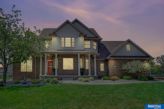 5441 S 88th St, Lincoln, NE 68526 - traditional-style house featuring a front yard, brick siding, and covered porch