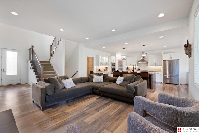 21034 X St, Omaha, NE 68022 - living area featuring wood finished floors, recessed lighting, and stairway