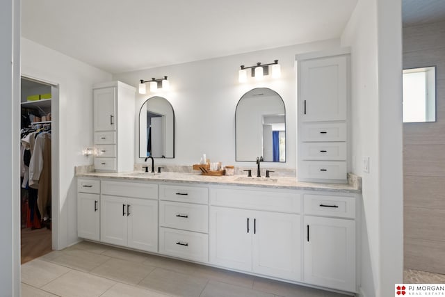 21034 X St, Omaha, NE 68022 - bathroom featuring double vanity, a walk in closet, and tile patterned flooring