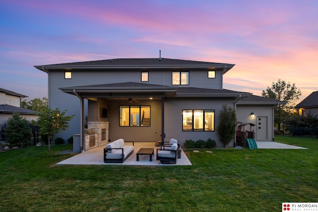 21034 X St, Omaha, NE 68022 - back of property at dusk featuring a patio area, ceiling fan, an outdoor kitchen, and an outdoor living space