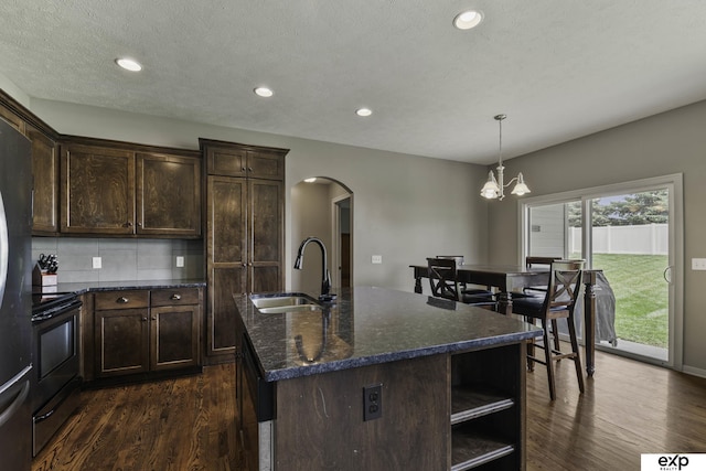 6015 S 193rd St, Omaha, NE 68135 - kitchen featuring electric stove, arched walkways, dark wood-type flooring, dark brown cabinetry, and recessed lighting
