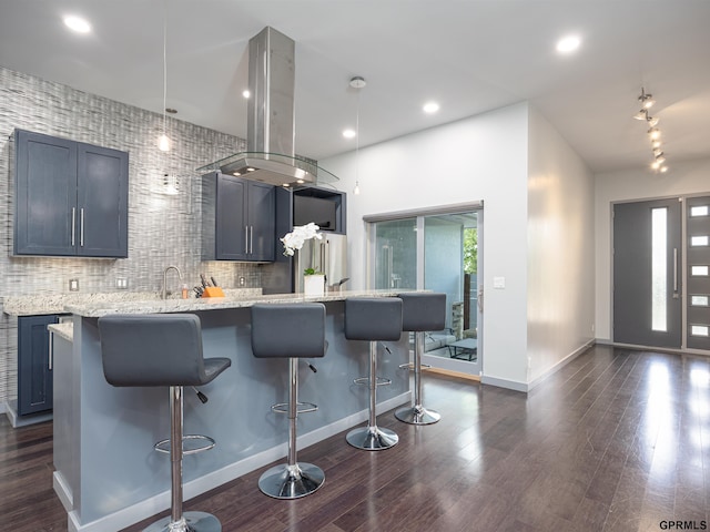 201 Bellevue Blvd N, Bellevue, NE 68005 - kitchen featuring a breakfast bar area, dark wood-style floors, and decorative backsplash