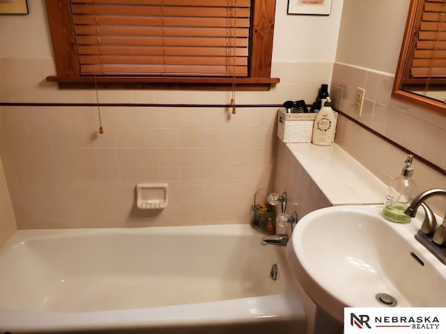 6409 Logan Ave, Lincoln, NE 68507 - full bathroom with tile walls and a tub to relax in