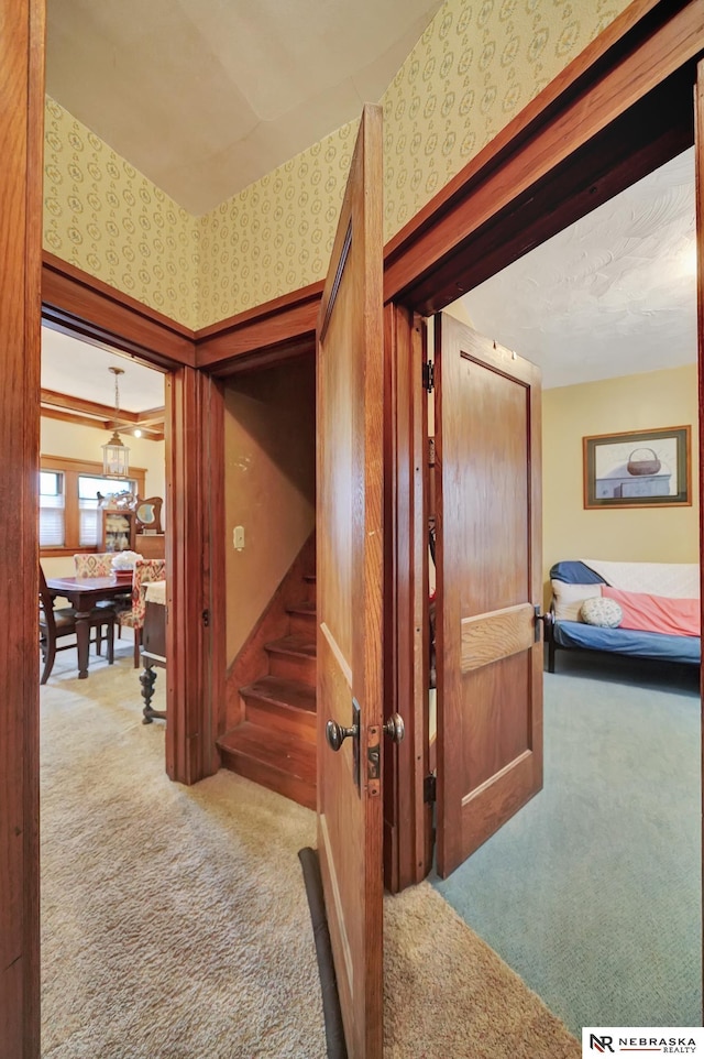 6409 Logan Ave, Lincoln, NE 68507 - corridor with carpet, wallpapered walls, and stairway