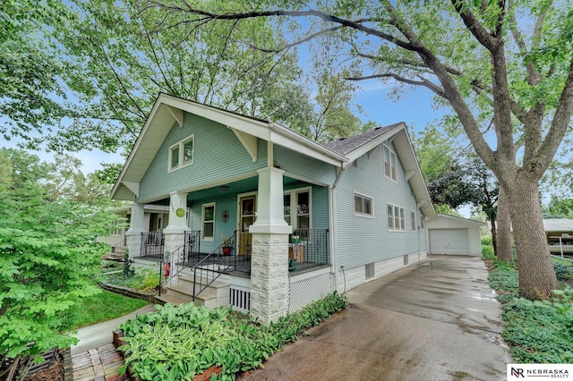 6409 Logan Ave, Lincoln, NE 68507 - view of front facade with a porch, a garage, and an outbuilding