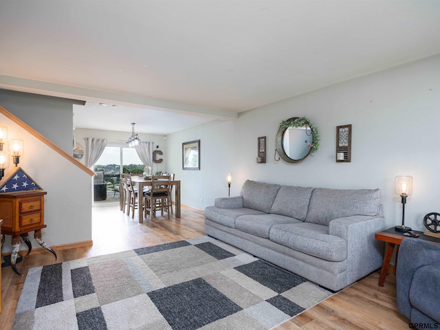 15413 Bondesson St, Bennington, NE 68007 - living area with wood finished floors, a chandelier, and stairs