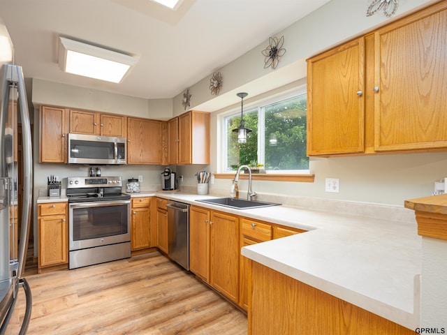 15413 Bondesson St, Bennington, NE 68007 - kitchen with appliances with stainless steel finishes, light countertops, light wood-type flooring, and pendant lighting