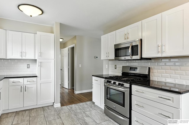 3207 S 121st St, Omaha, NE 68144 - kitchen with appliances with stainless steel finishes, white cabinets, dark countertops, tasteful backsplash, and crown molding