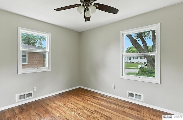 3207 S 121st St, Omaha, NE 68144 - unfurnished room featuring plenty of natural light, wood finished floors, and a ceiling fan