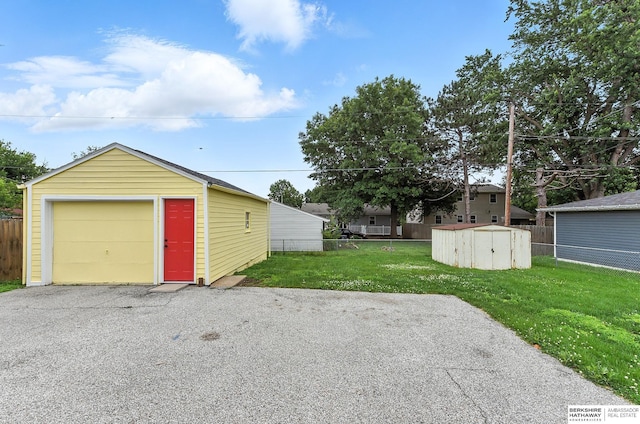 3207 S 121st St, Omaha, NE 68144 - detached garage featuring asphalt driveway and a shed