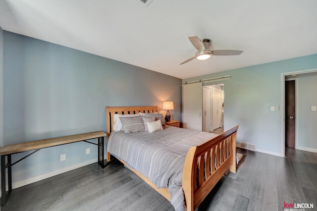 4000 S 56th St Unit 130C, Lincoln, NE 68516 - bedroom featuring wood finished floors, ceiling fan, and a barn door