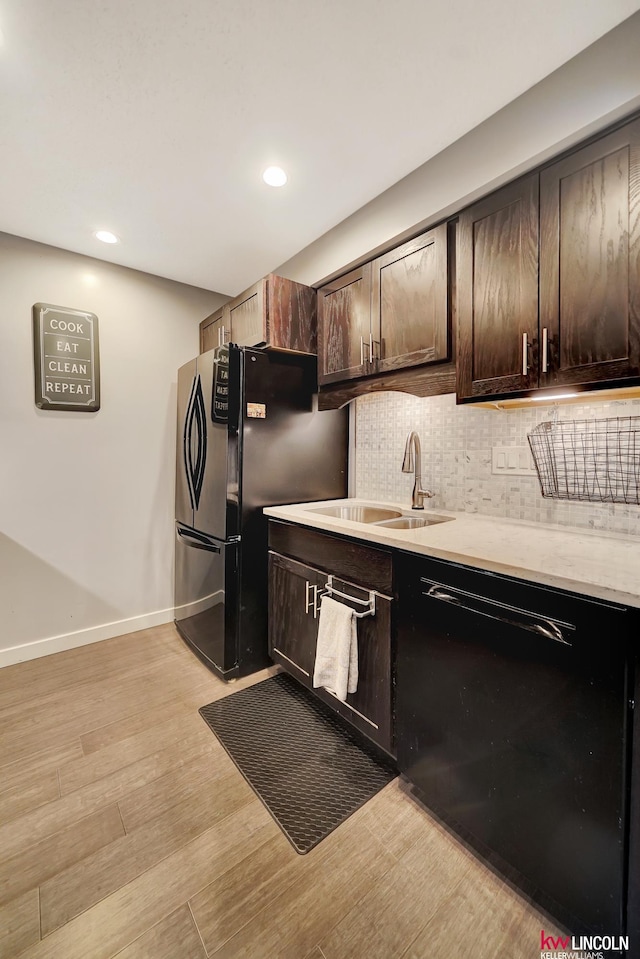 4000 S 56th St Unit 130C, Lincoln, NE 68516 - kitchen with black appliances, light wood-style flooring, light countertops, dark brown cabinets, and decorative backsplash