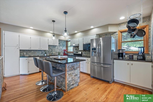 754 10th St, Syracuse, NE 68446 - kitchen with appliances with stainless steel finishes, dark countertops, light wood-style floors, and recessed lighting