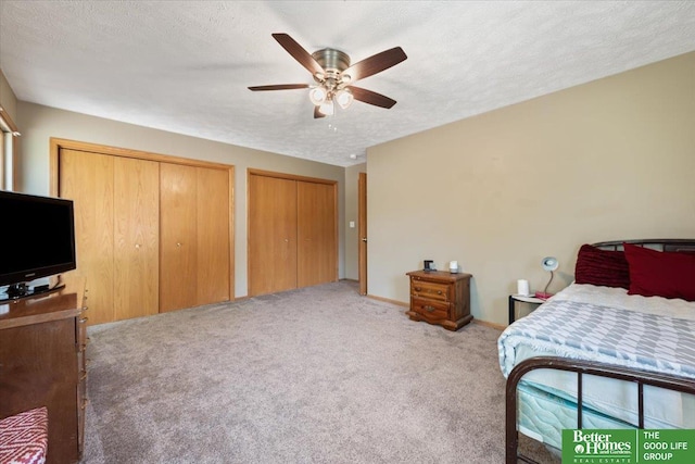 754 10th St, Syracuse, NE 68446 - bedroom with carpet floors, multiple closets, a textured ceiling, and a ceiling fan