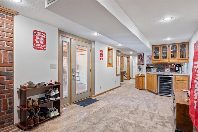 754 10th St, Syracuse, NE 68446 - indoor wet bar featuring beverage cooler, recessed lighting, and stairway