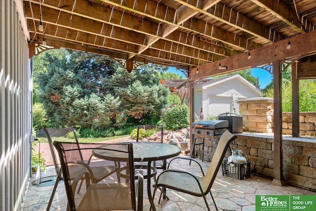 754 10th St, Syracuse, NE 68446 - view of patio / terrace featuring outdoor dining space and an outbuilding